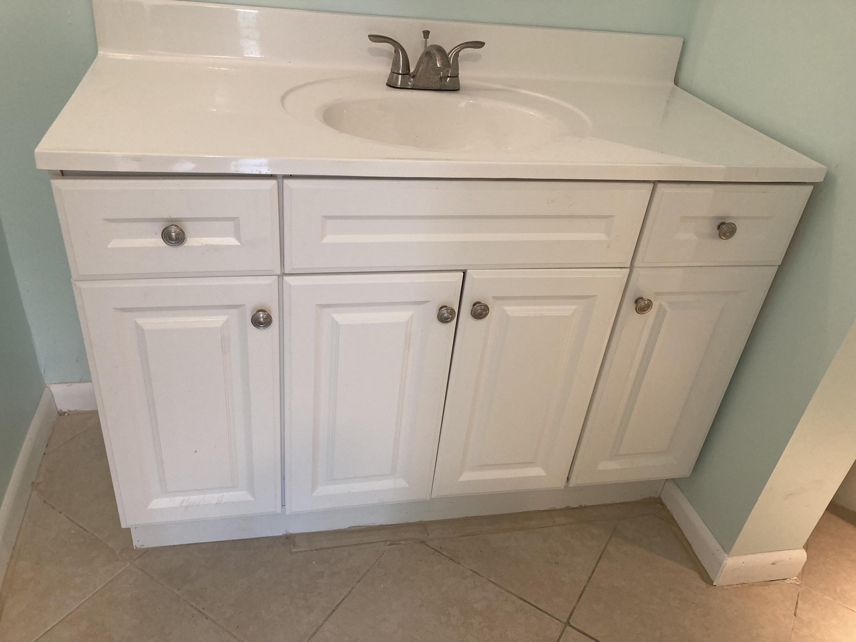11811 Ave Of The PGA, Unit 21C Palm Beach Gardens, FL 33418 - Photo 26 of 30 a bathroom with a sink and vanity