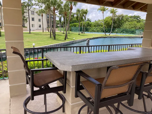 a balcony with table and chairs