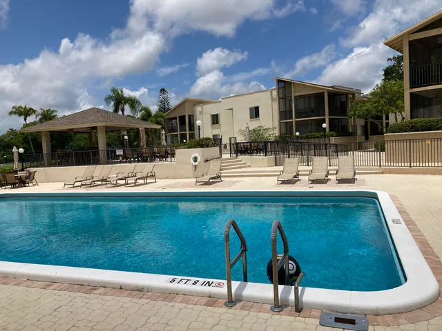 a view of a patio with swimming pool table and chairs