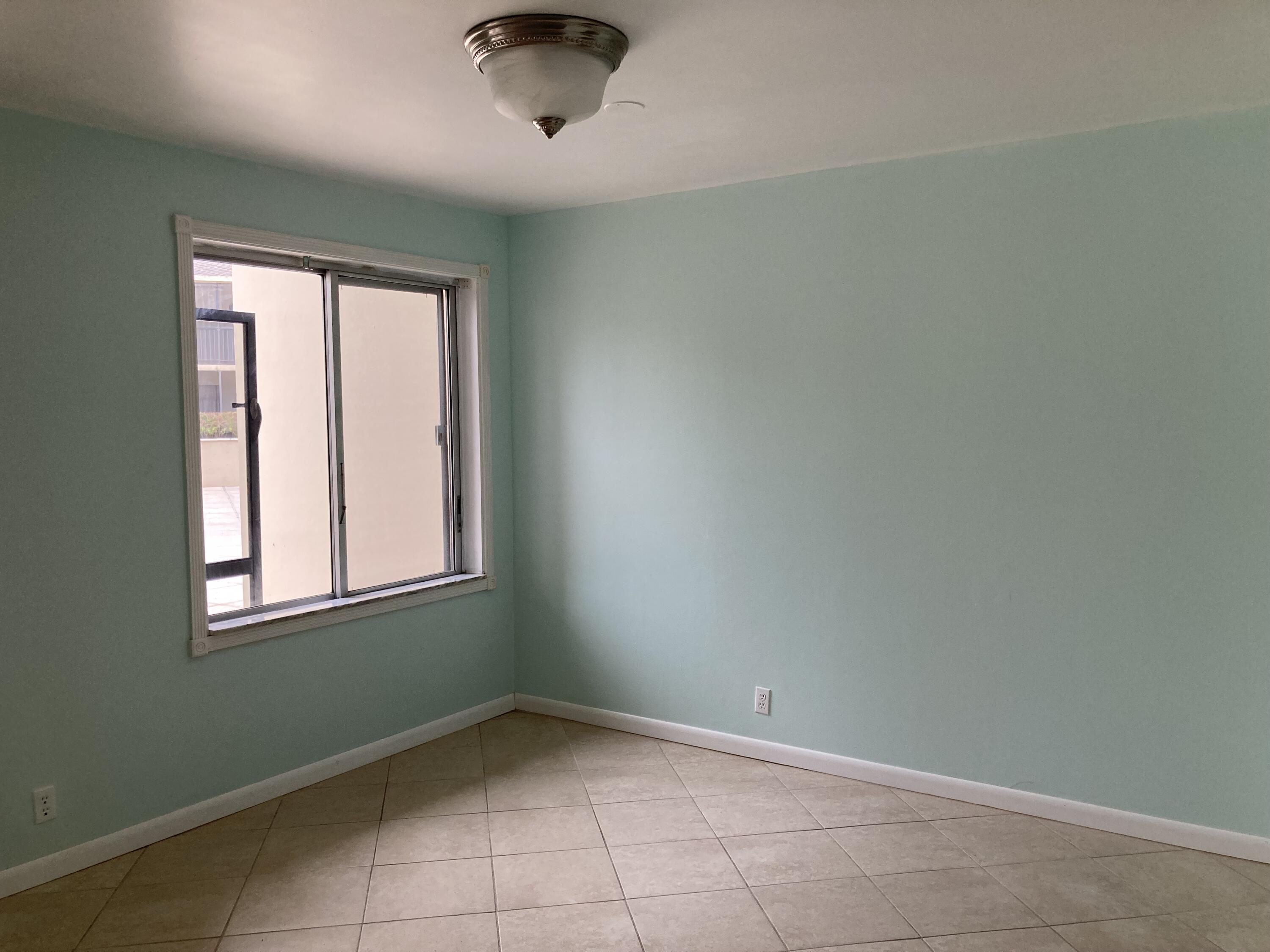 11811 Ave Of The PGA, Unit 21C Palm Beach Gardens, FL 33418 - Photo 10 of 30 an empty room with a window
