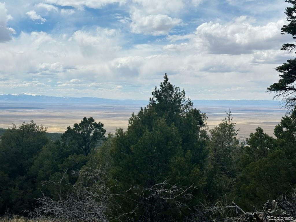 313 Arrastre Road Mosca, CO 81146 - Photo 18 of 18 a view of a lake with a house in back