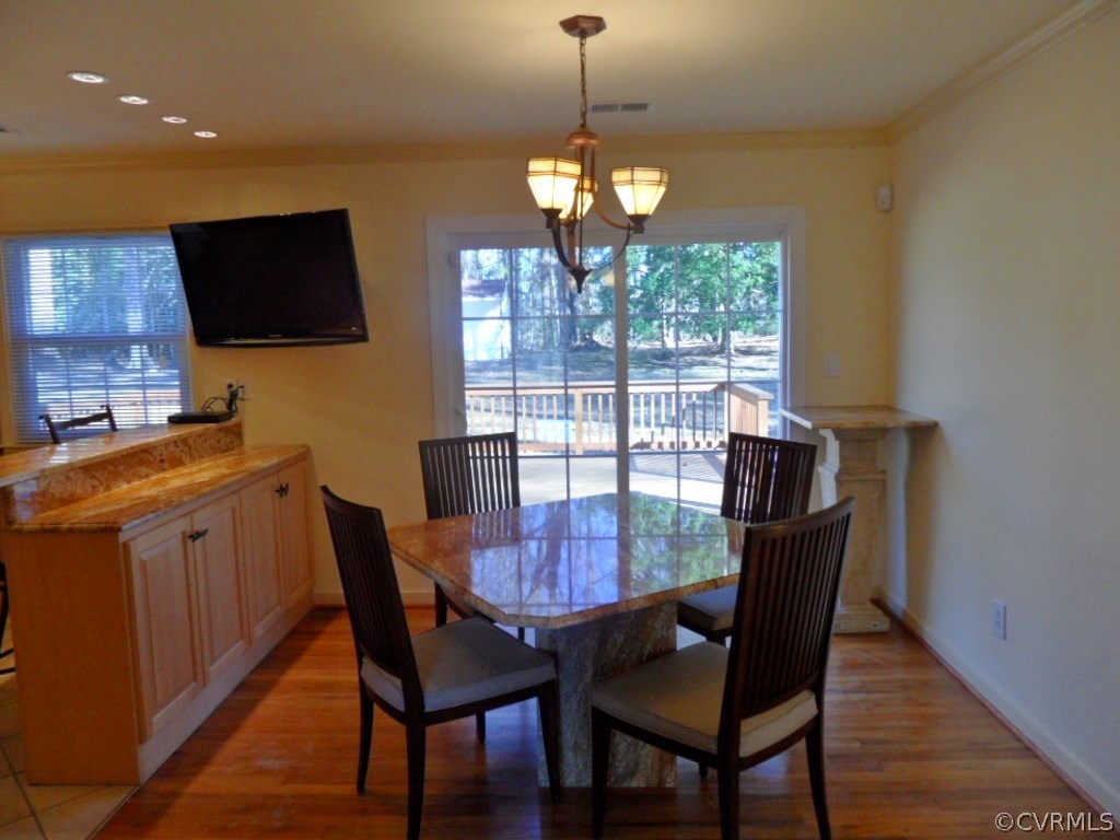 3725 Cheyenne Road Richmond, VA 23235 - Photo 12 of 24 a view of a dining room with furniture window and wooden floor