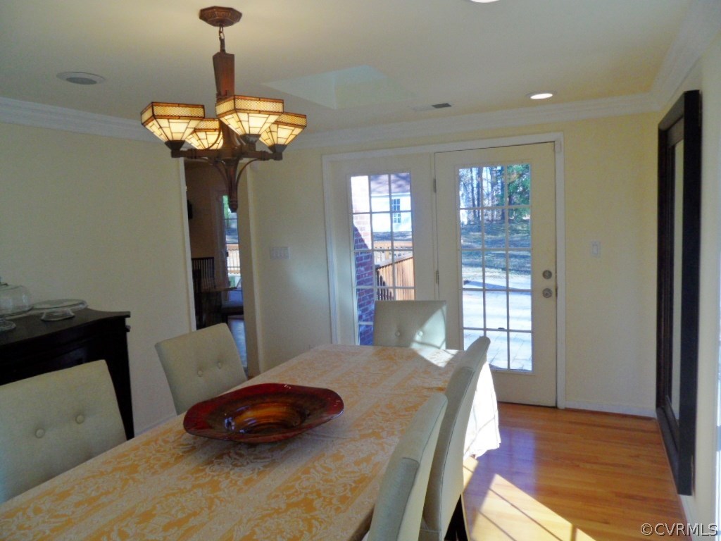 3725 Cheyenne Road Richmond, VA 23235 - Photo 14 of 24 a bedroom with a bed and a chandelier