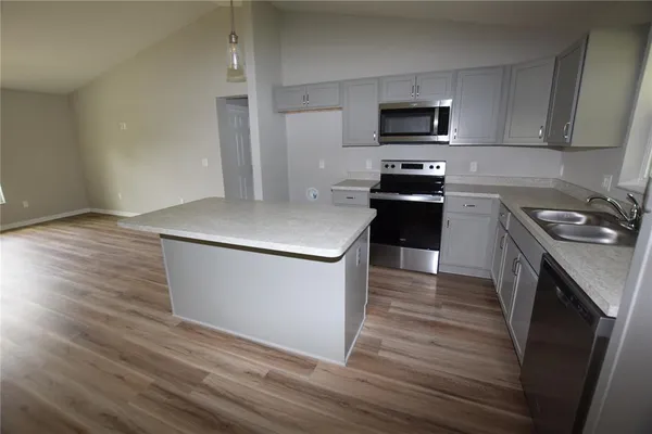 a kitchen with a sink a stove and microwave