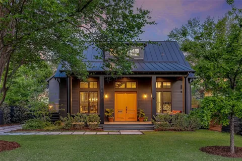 a front view of house with a garden