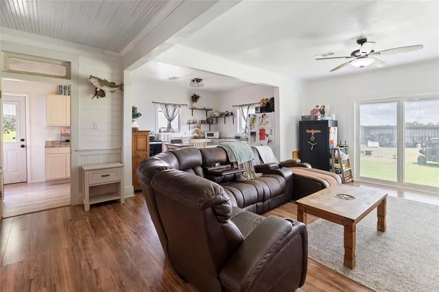 a kitchen with stainless steel appliances granite countertop a sink a stove a dining table and chairs