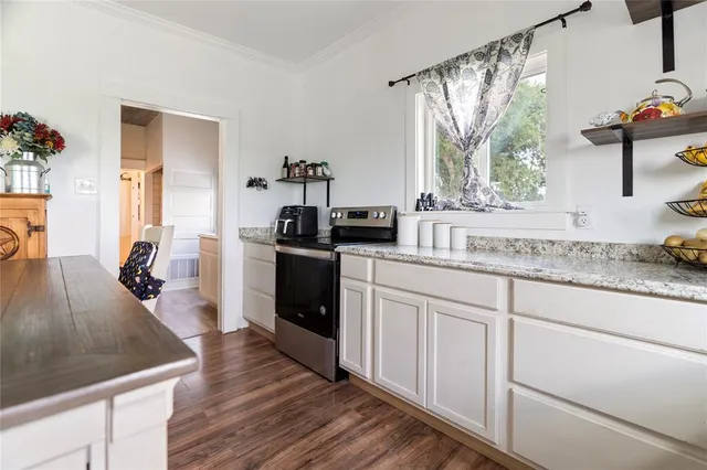 a bedroom with a bed wooden floor and window