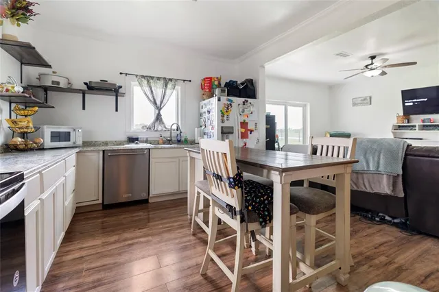 a bedroom with a bed a flat screen tv and a chandelier
