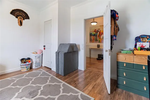 a bedroom with a bed a dresser and a window