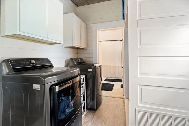 a view of a balcony with wooden floor and seating space
