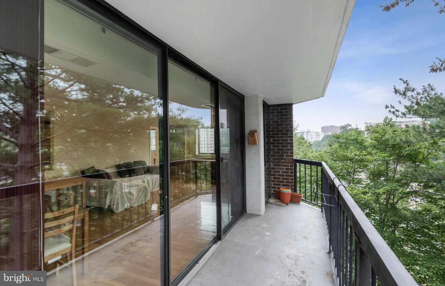 1401 North Rhodes Street, Unit 406 Arlington, VA 22209 - Photo 13 of 14 Serene balcony with lush views.