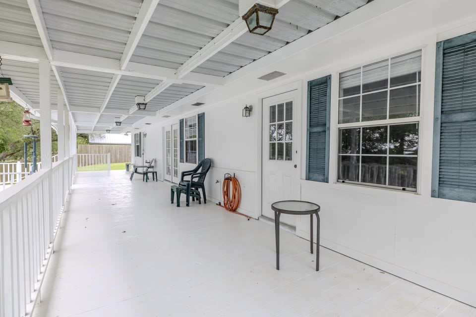 483 Riverside Drive Palacios, TX 77465 - Photo 34 of 41 a view of a porch with chairs and backyard
