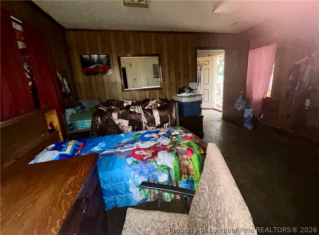 918 Opal Road Red Springs, NC 28377 - Photo 6 of 26 a bedroom with a bed purple white bedspread and pillows