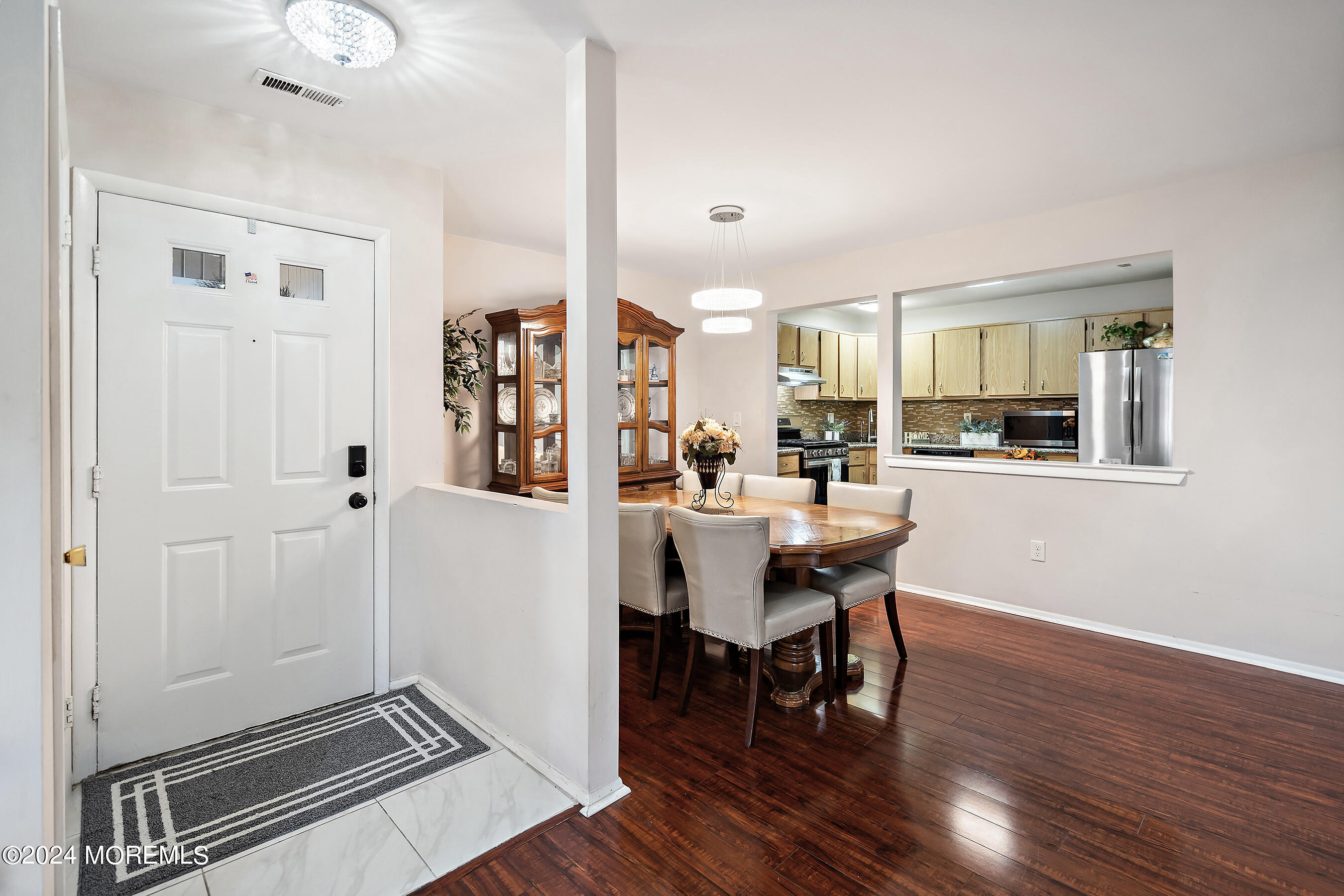 509 Harding Road, Unit 2 Freehold, NJ 07728 - Photo 11 of 24 a view of a dining room with furniture and wooden floor