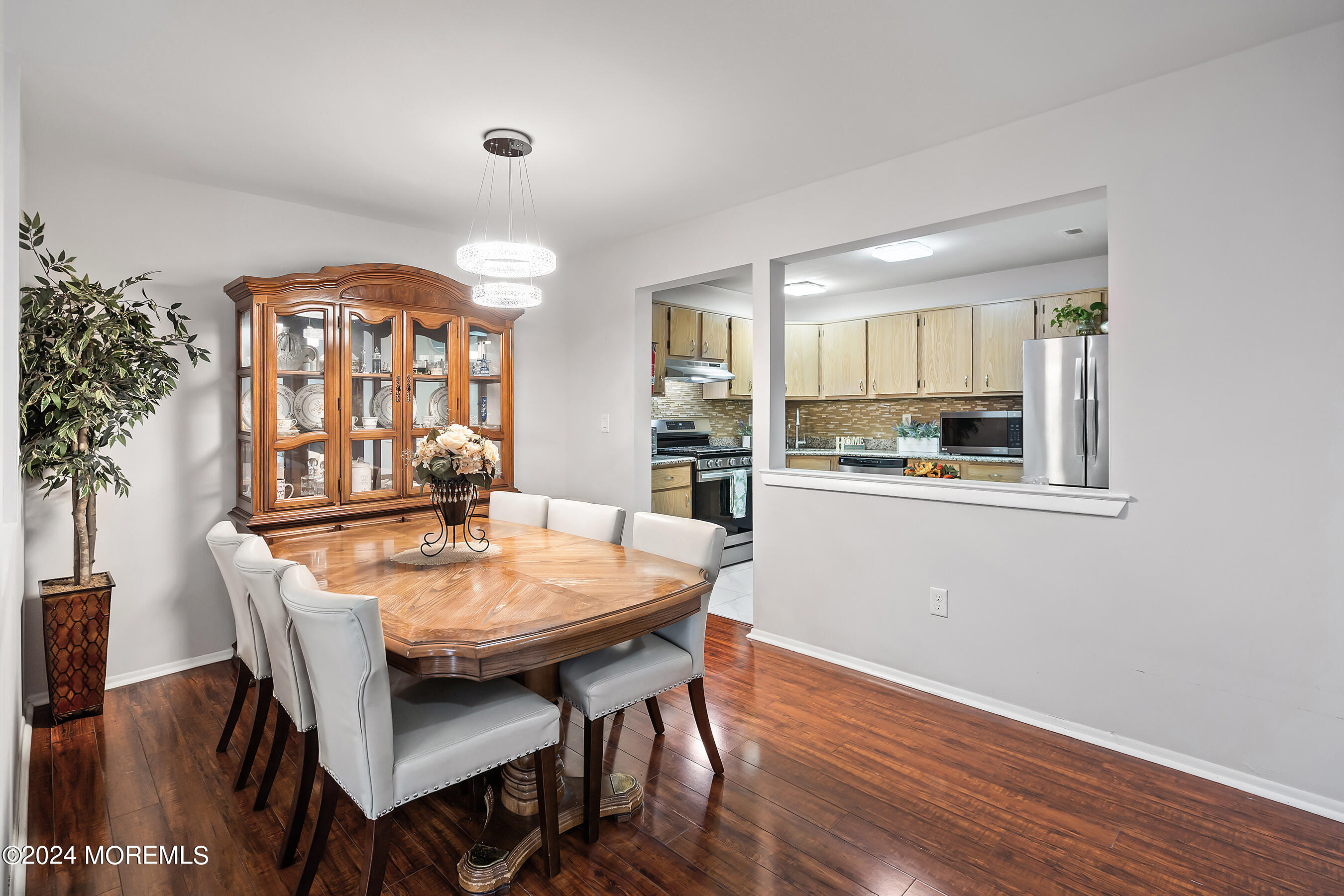 509 Harding Road, Unit 2 Freehold, NJ 07728 - Photo 13 of 24 a dining room with furniture a window and wooden floor