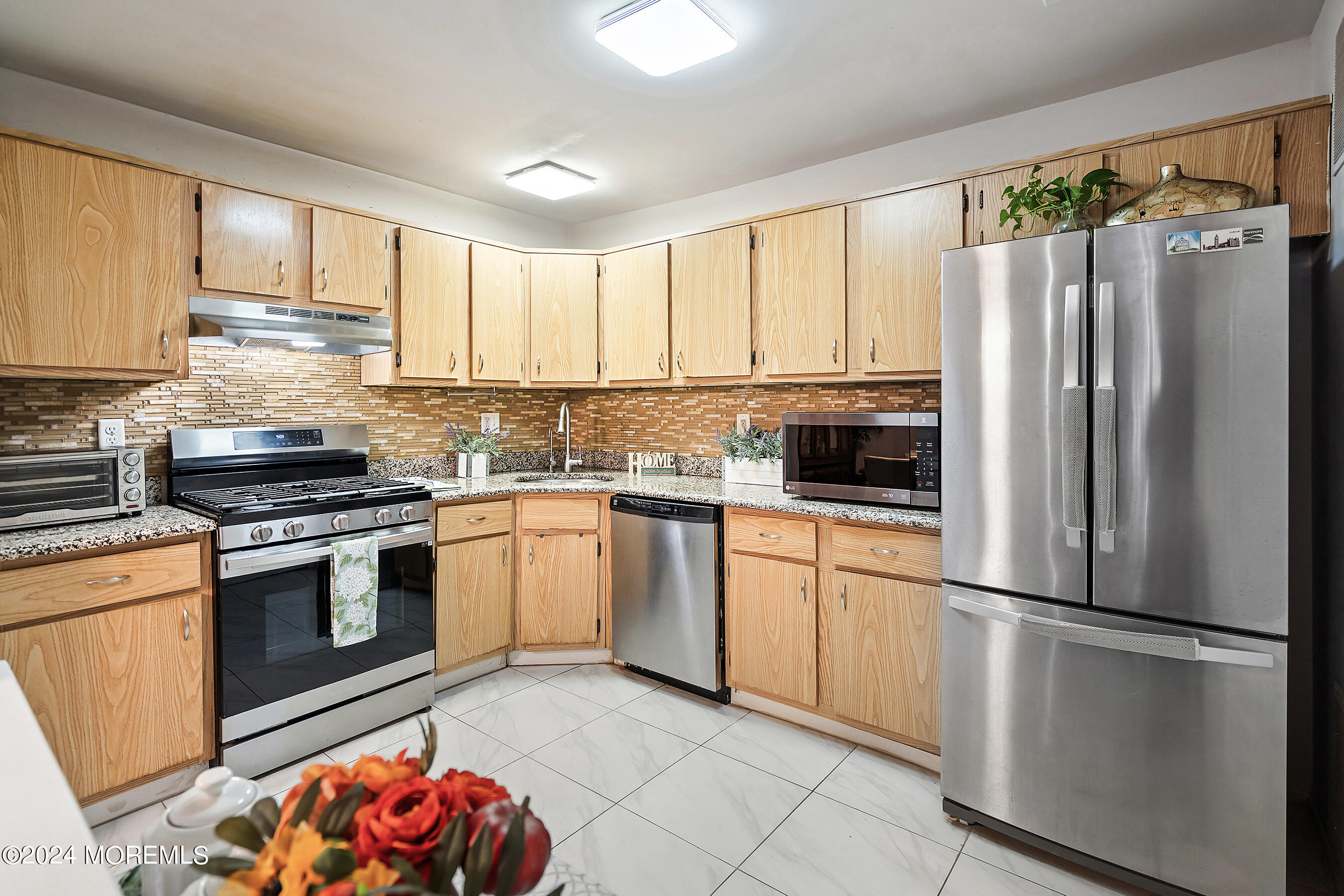 509 Harding Road, Unit 2 Freehold, NJ 07728 - Photo 14 of 24 a kitchen with granite countertop a refrigerator stove top oven and sink