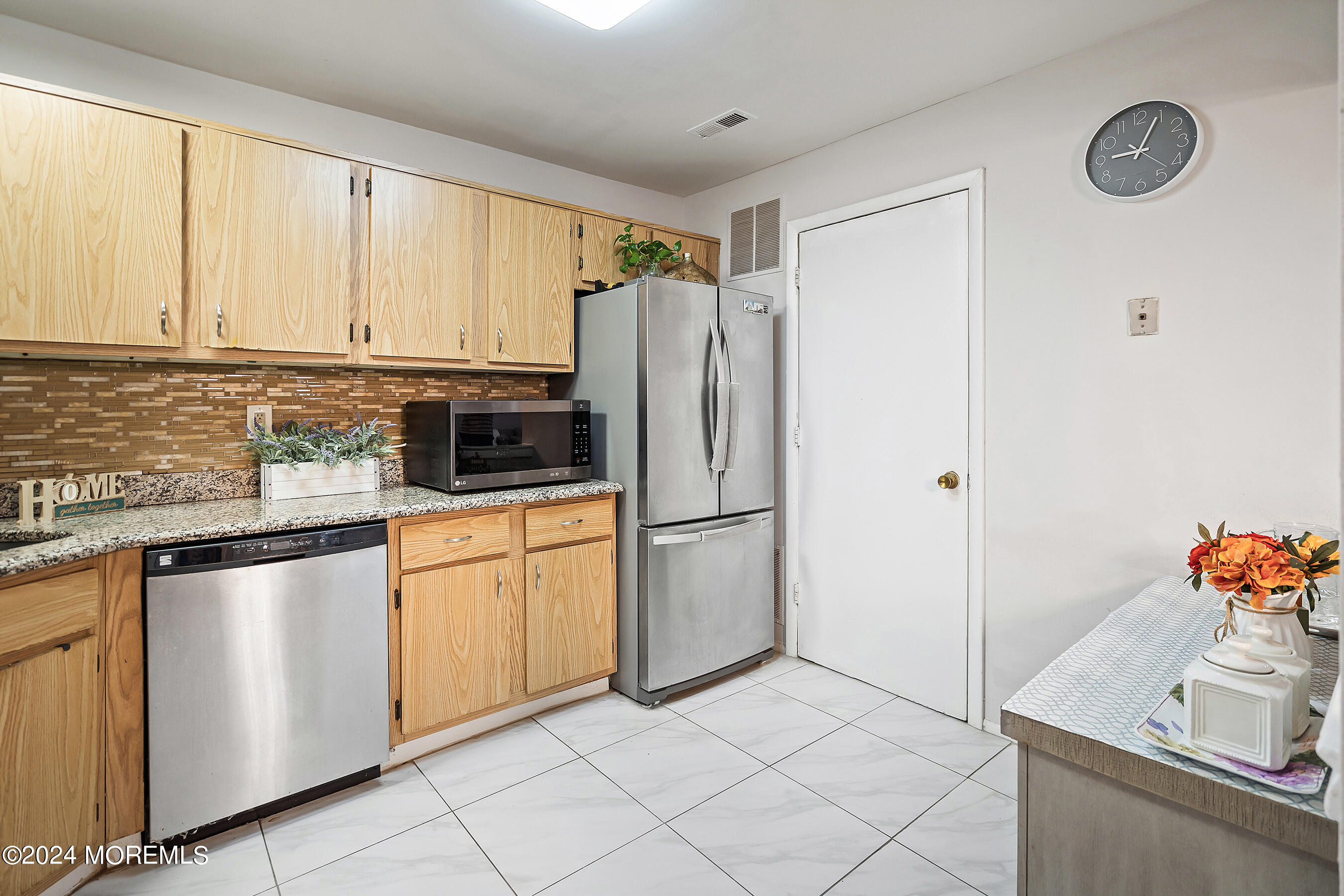 509 Harding Road, Unit 2 Freehold, NJ 07728 - Photo 15 of 24 a kitchen with stainless steel appliances granite countertop a refrigerator sink and cabinets