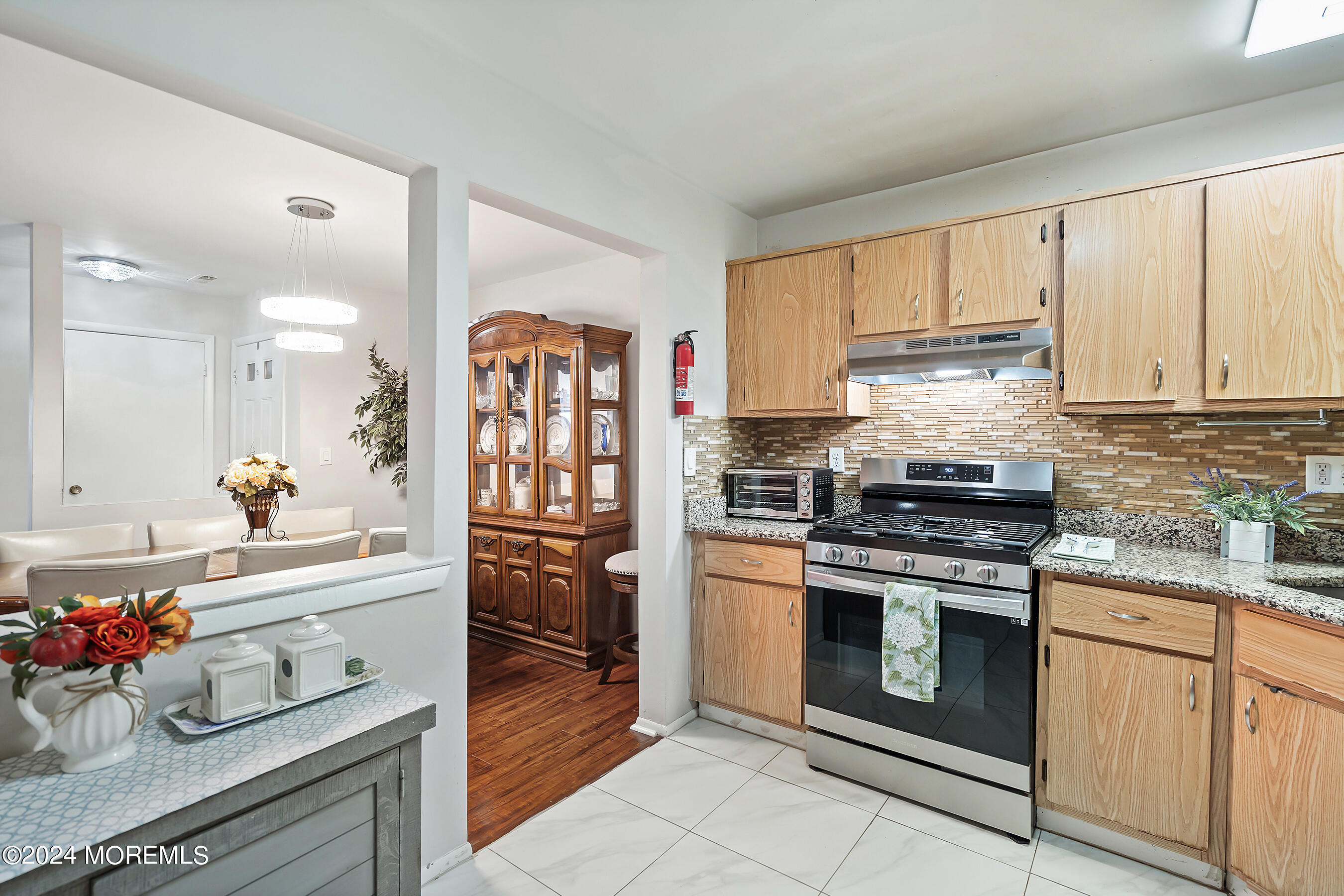 509 Harding Road, Unit 2 Freehold, NJ 07728 - Photo 17 of 24 a kitchen with stainless steel appliances granite countertop a stove a sink and a refrigerator