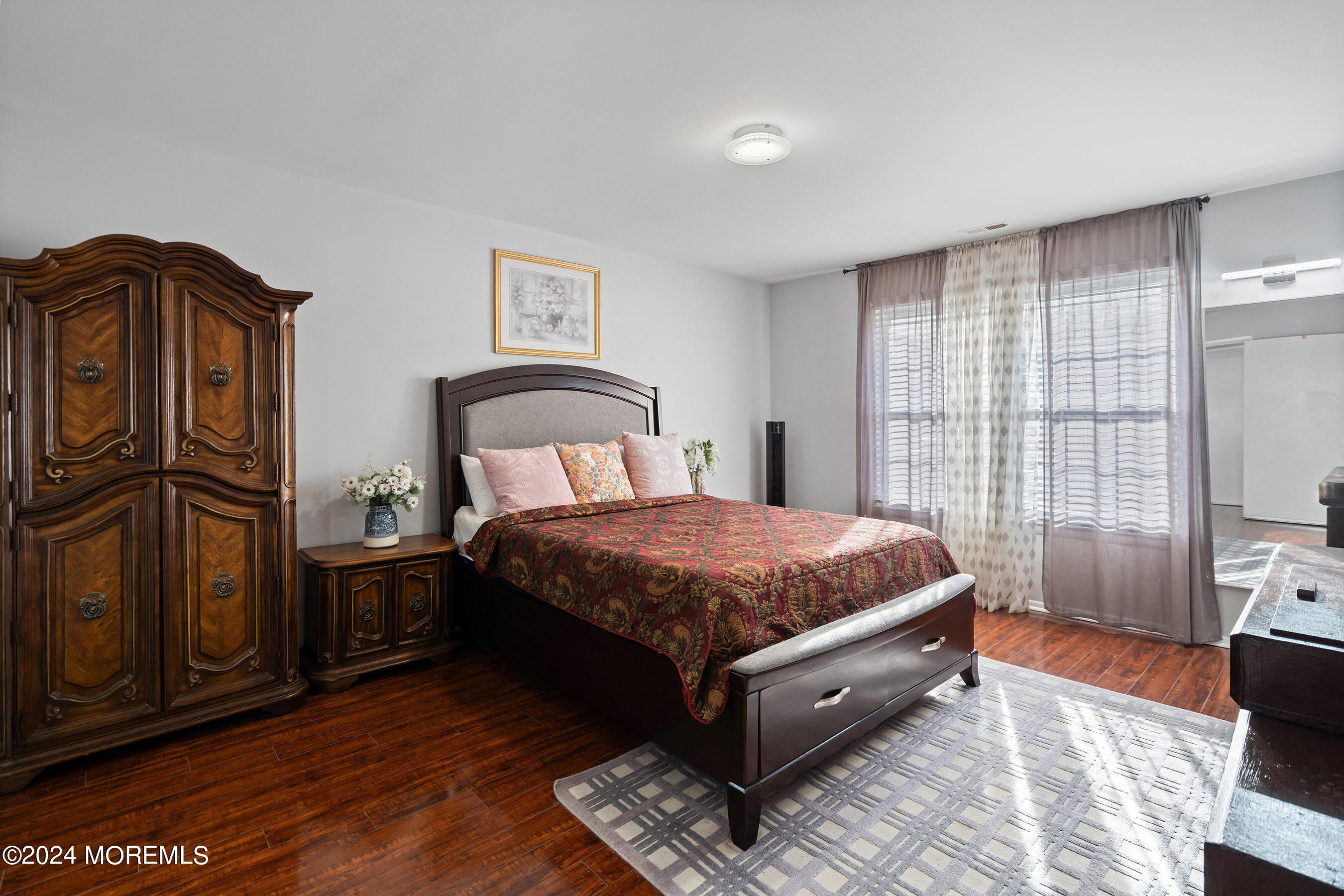 509 Harding Road, Unit 2 Freehold, NJ 07728 - Photo 18 of 24 a spacious bedroom with a bed and wooden floor