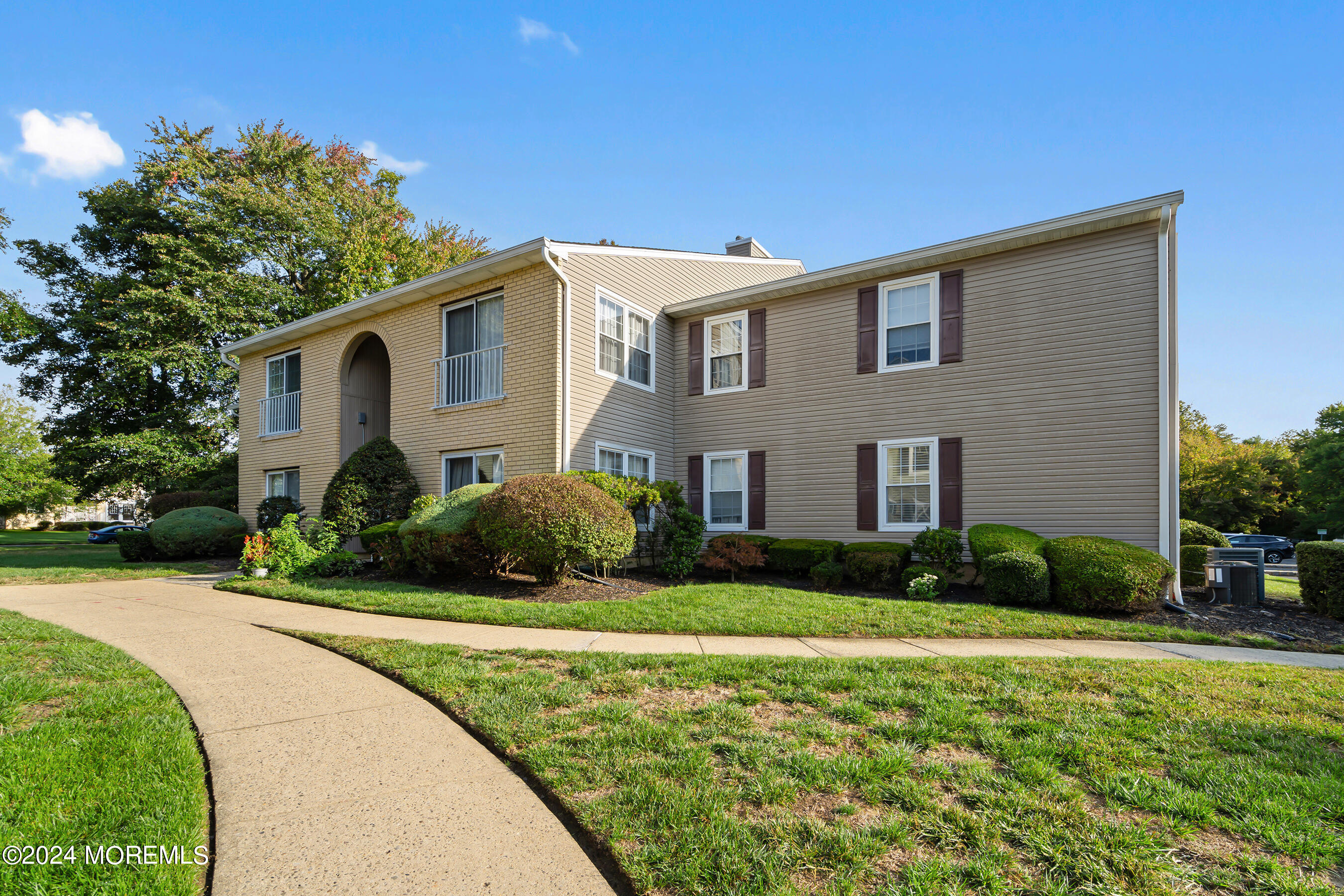 509 Harding Road, Unit 2 Freehold, NJ 07728 - Photo 2 of 24 a front view of a house with garden
