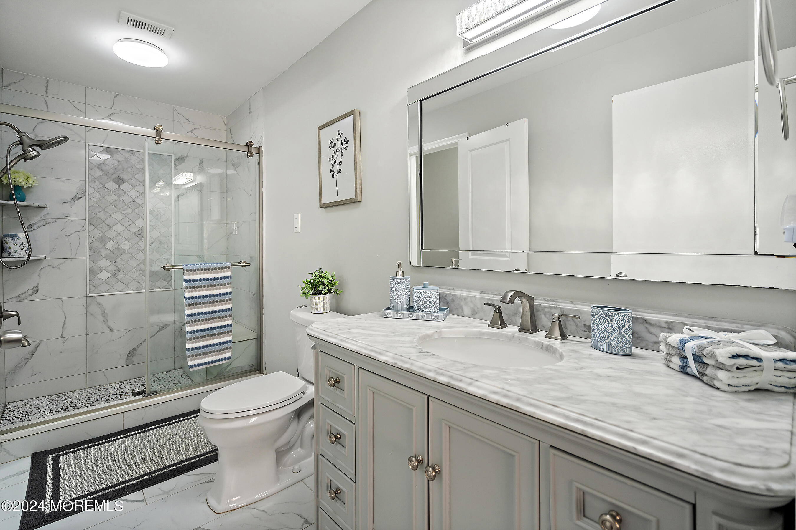 509 Harding Road, Unit 2 Freehold, NJ 07728 - Photo 21 of 24 a bathroom with a granite countertop sink a toilet and shower