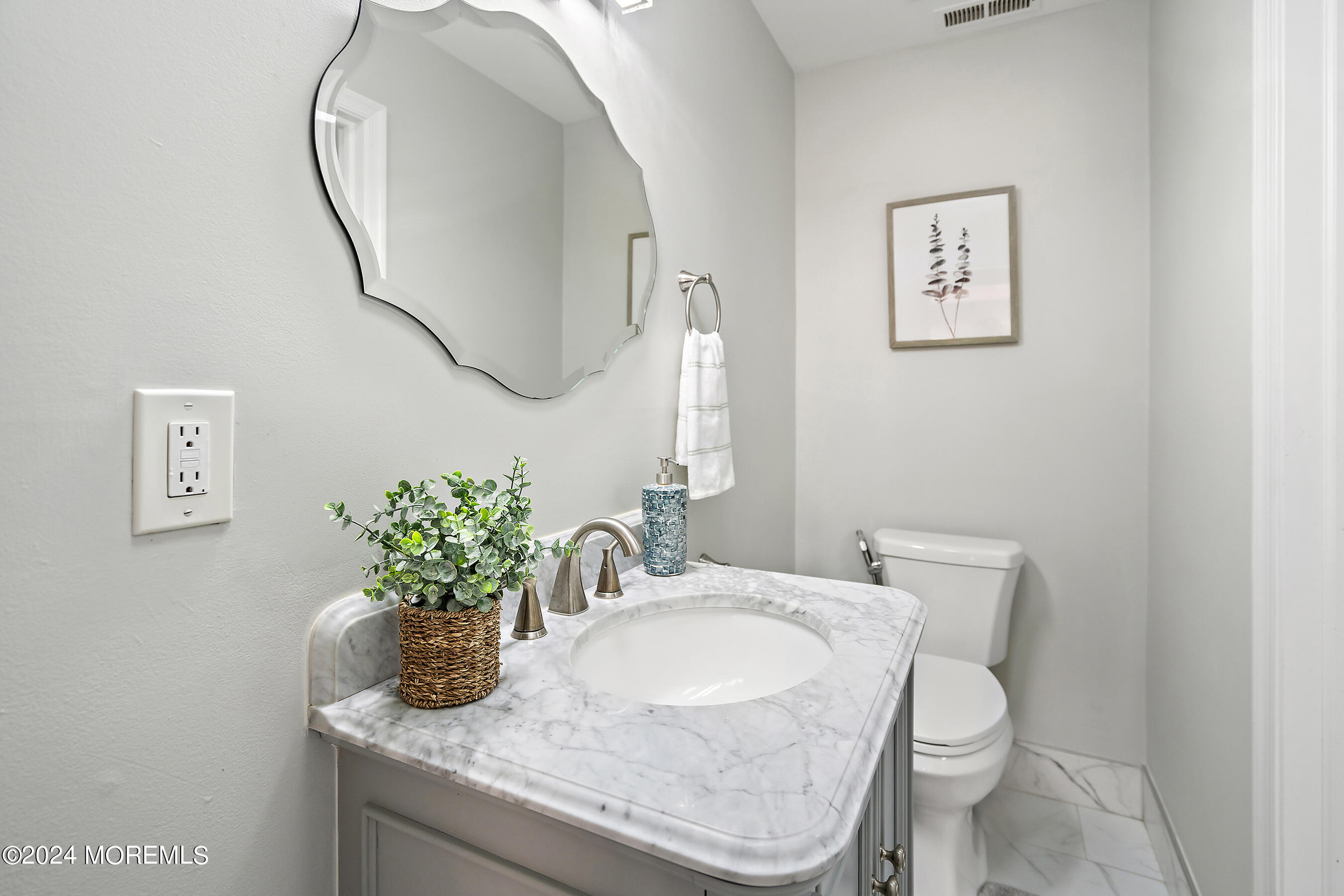 509 Harding Road, Unit 2 Freehold, NJ 07728 - Photo 24 of 24 a bathroom with a granite countertop toilet a sink and a mirror
