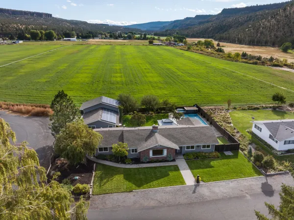 an aerial view of a house with garden space and outdoor seating