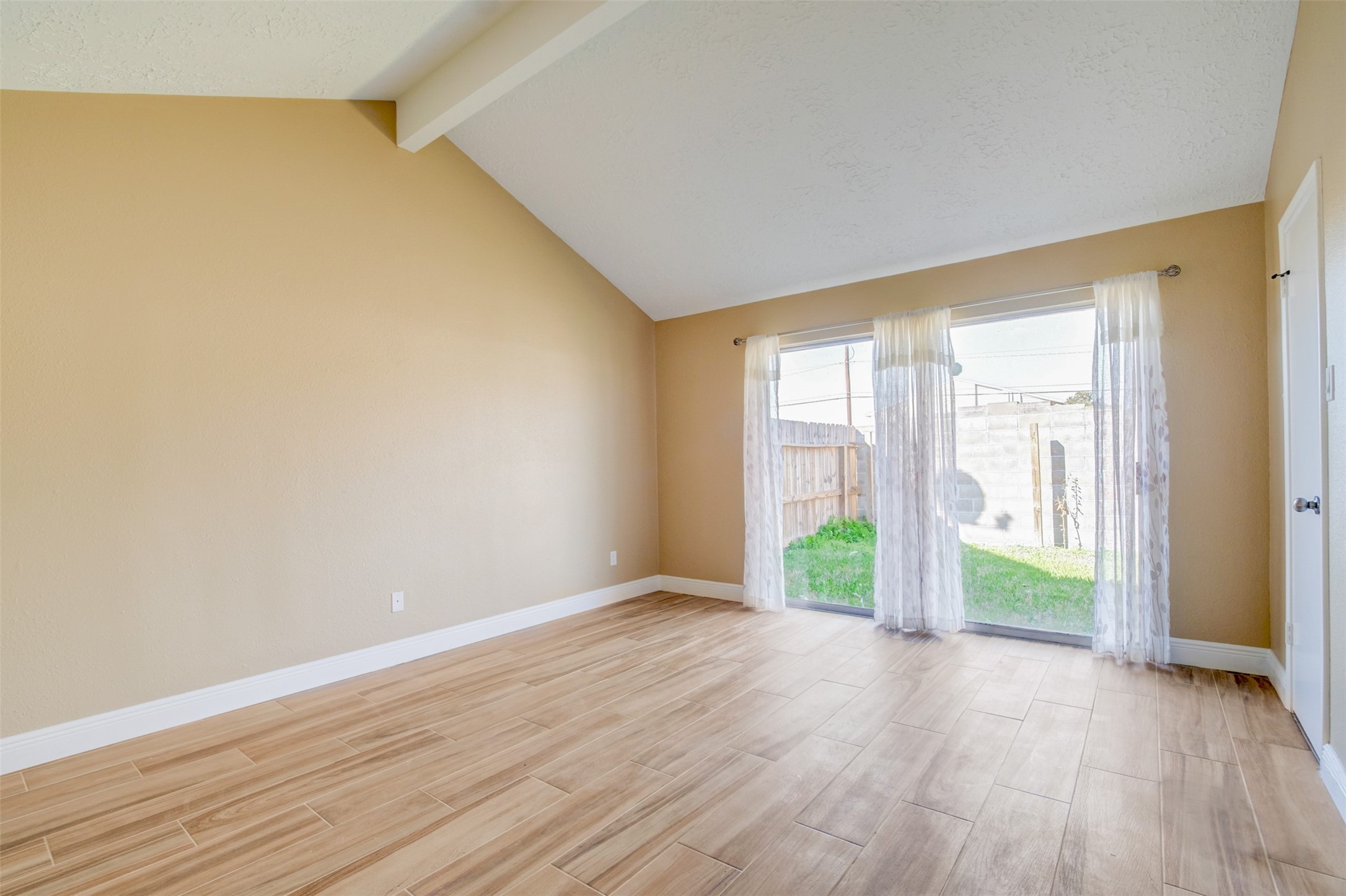 11840 Spring Grove Drive Houston, TX 77099 - Photo 14 of 27 Stunning primary bedroom with high ceilings and sliding door to patio