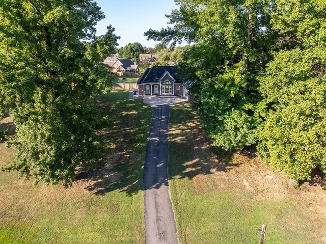 a picture of a tree in front of a house