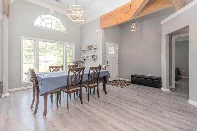 a view of a dining room with furniture window and wooden floor