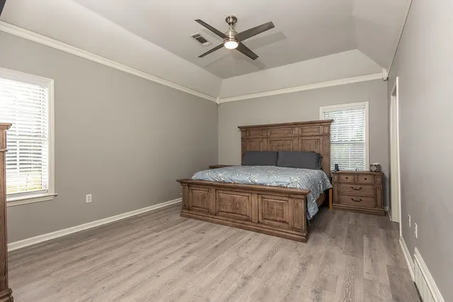 a bedroom with a bed and a ceiling fan