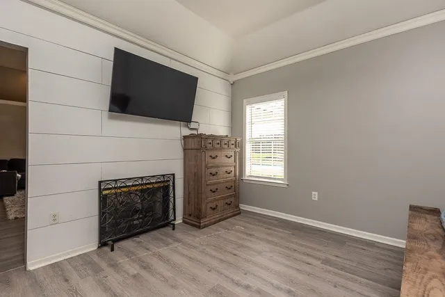 a living room with a fireplace and a flat screen tv