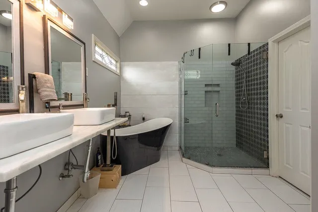a bathroom with a shower sink and mirror