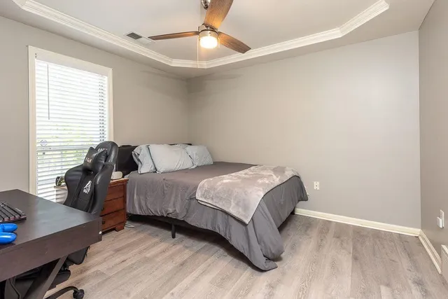 a bedroom with a bed and a desk