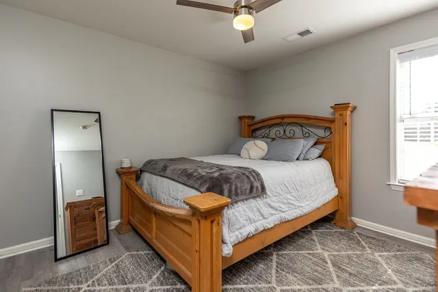 a bedroom with a bed and window