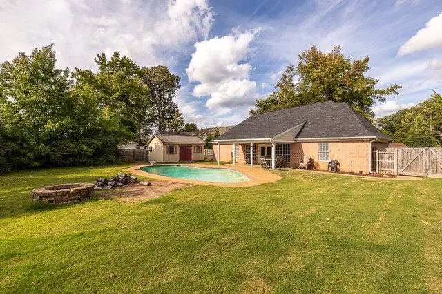a front view of a house with swimming pool having outdoor seating