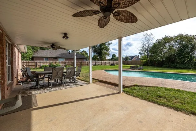 a view of a patio with a table and chairs