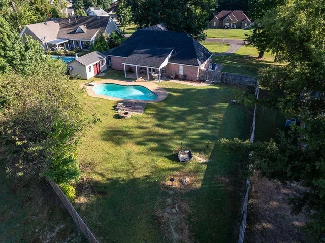 a swimming pool with outdoor seating and yard