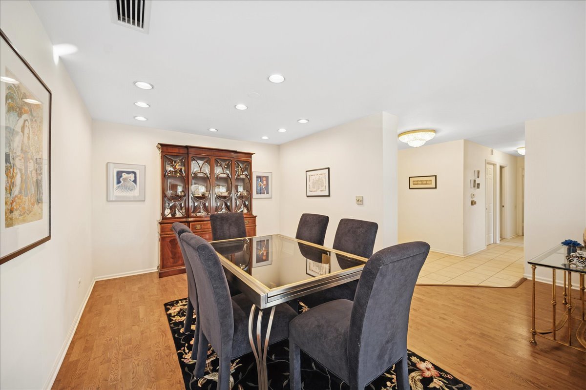 1771 Mission Hills Road, Unit 212 Northbrook, IL 60062 - Photo 11 of 22 a view of a dining room with furniture and wooden floor