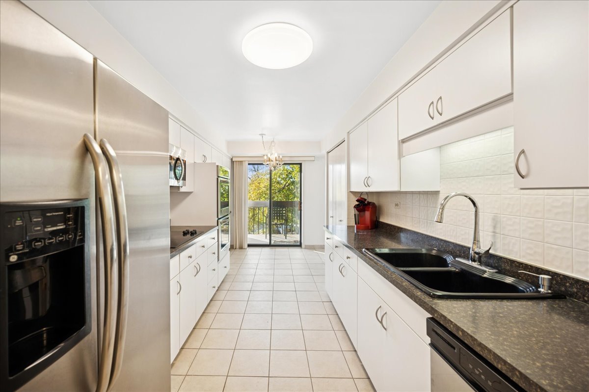 1771 Mission Hills Road, Unit 212 Northbrook, IL 60062 - Photo 12 of 22 a kitchen with stainless steel appliances granite countertop a sink a stove and a refrigerator