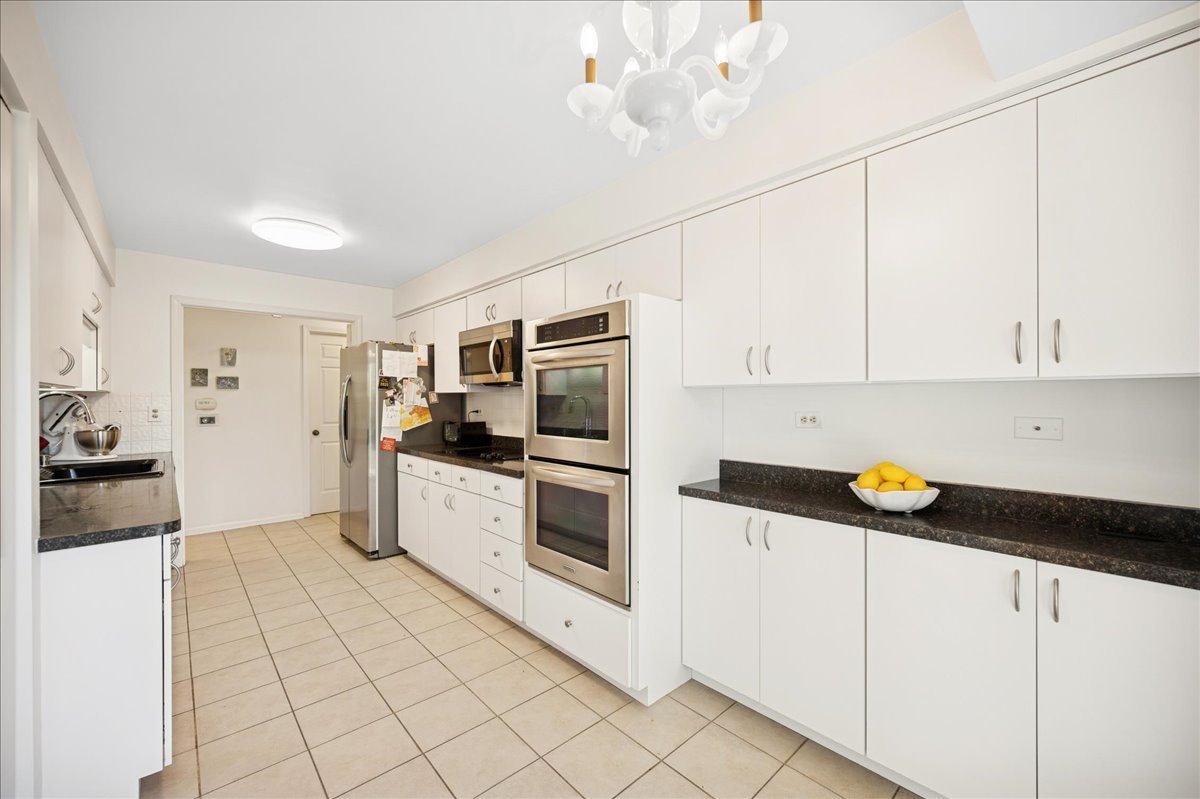 1771 Mission Hills Road, Unit 212 Northbrook, IL 60062 - Photo 13 of 22 a kitchen with stainless steel appliances a refrigerator sink and cabinets