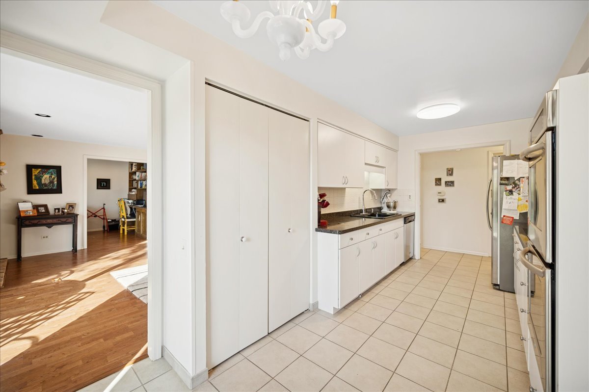 1771 Mission Hills Road, Unit 212 Northbrook, IL 60062 - Photo 14 of 22 a kitchen with stainless steel appliances a refrigerator and a stove top oven