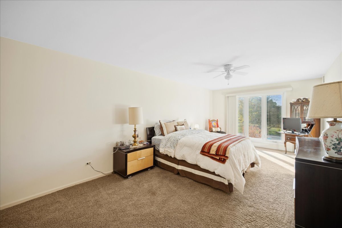 1771 Mission Hills Road, Unit 212 Northbrook, IL 60062 - Photo 15 of 22 a bedroom with a bed and wooden floor