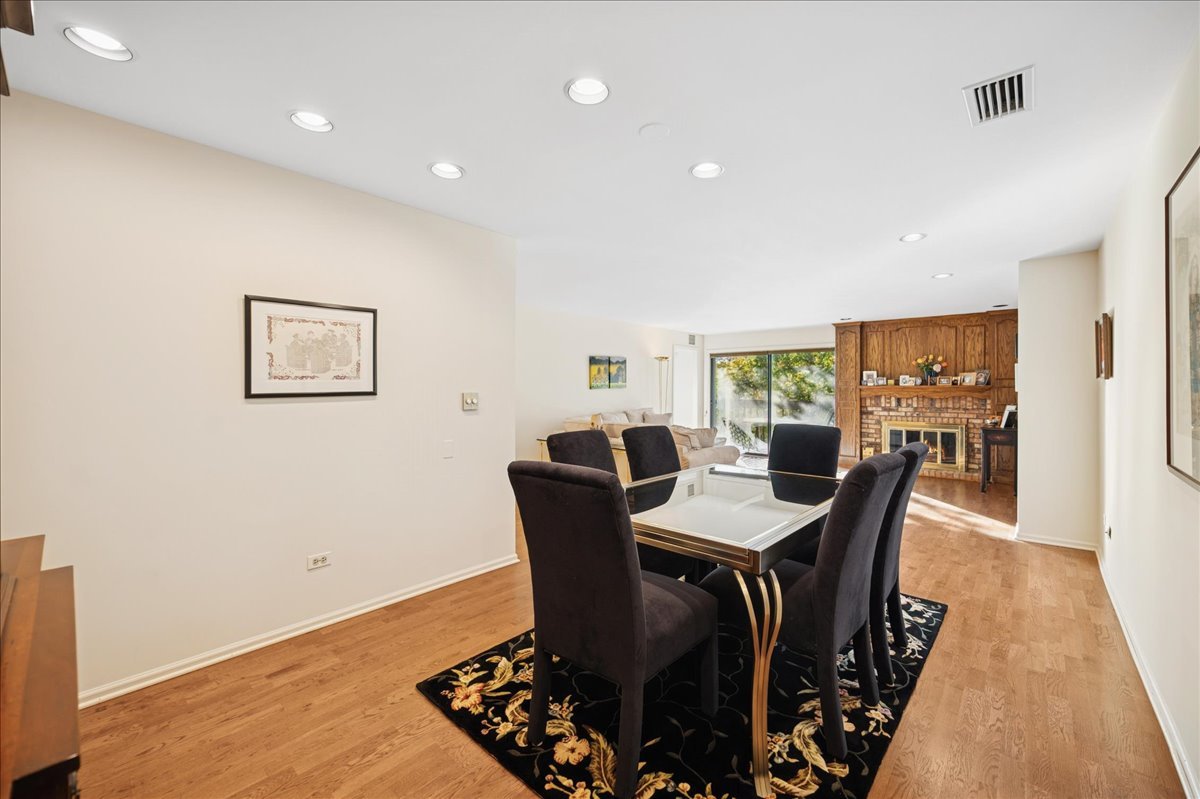 1771 Mission Hills Road, Unit 212 Northbrook, IL 60062 - Photo 10 of 22 a view of a dining room with furniture window and wooden floor