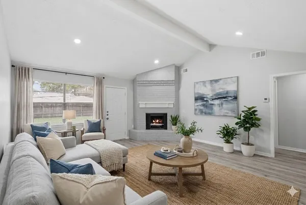 a living room with furniture and a fireplace