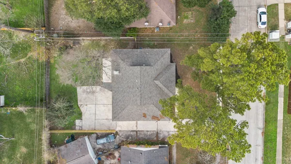 an aerial view of a house with a yard