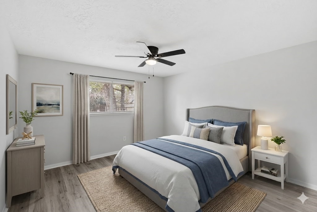 23111 Canyon Lake Drive Spring, TX 77373 - Photo 6 of 24 Secondary bedroom with wood-look flooring, ceiling fan, and a window with views of the side yard. Room is virtually staged.