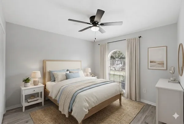 a bedroom with a bed and a chandelier