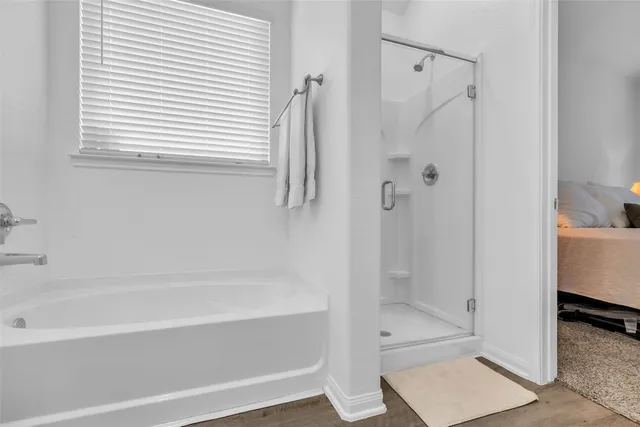 a bathroom with a bathtub and a shower