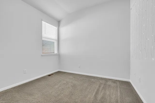 a bathroom with a granite countertop sink a toilet and a mirror